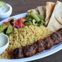 Lule Kebab Plate · Skewered ground beef sirloin served over rice pilaf, side salad, two side picks & pita bread.