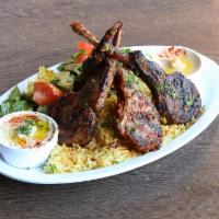 Lamb Chops Plate · Seasoned & grilled New Zealand rack of lamb served over rice pilaf, side salad, two side pic...