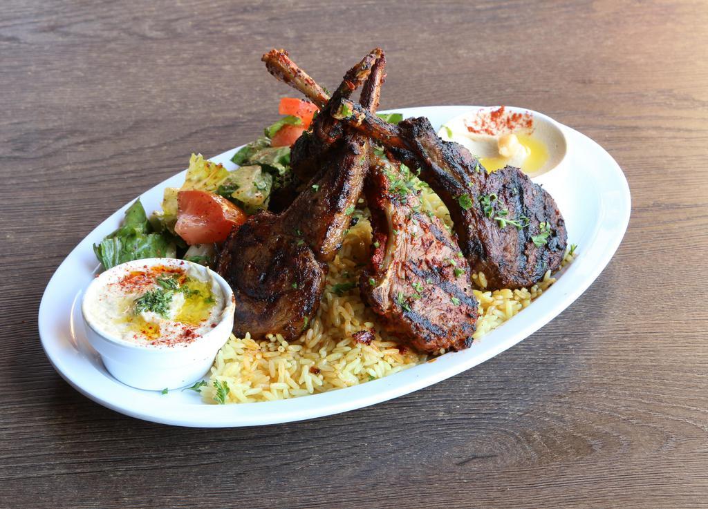 Lamb Chops Plate · Seasoned & grilled New Zealand rack of lamb served over rice pilaf, side salad, two side picks & pita bread.