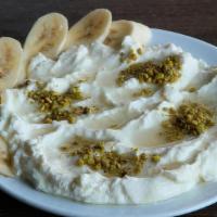 Ashta · Cherimoya Cream drizzled with syrup, topped with slices of banana & crushed pistachio