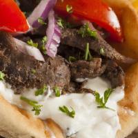 Gyro Pita Sandwich · Layering gyro meat, lettuce, tomatoes, red onion, and homemade tzatziki sauce served in a Pi...