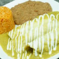 Enchiladas Suizas · Wrapped corn tortilla filled with chicken. dipped in our green creamy sauce topped with melt...