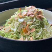 Brussels Salad · Shaved brussels sprouts, mandarines, toasted almonds.