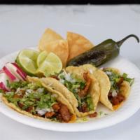 Tacos · handmade corn tortilla, choice of meat, cilantro & onions.