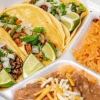 3 Tacos Lengua Combo · Cabbage, cilantro, and onions with a side of rice and beans.