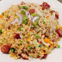 Creasian Fried Rice With Choice Of Meat · Fried rice with egg, peas, carrot, and onion with choice of meat.