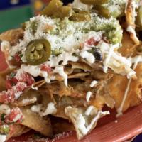 Nachos · beans - cheddar & jack cheese - cotija cheese - guacamole - sour cream