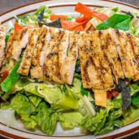 Chicken Caesar Salad · Crisp romaine lettuce, diced tomatoes, cotija cheese, pepita seeds, and tortilla strips. Tos...