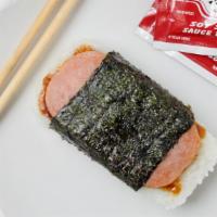 Spam Musubi · A grilled slice of spam layered on top of white rice and teriyaki sauce, wrapped with a shee...