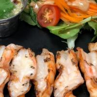 Grilled Shrimps · Shrimps on skewers served with small salad, and the side of chili garlic lime sauce