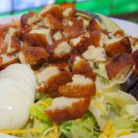 Fried Chicken Salad · A mountain of our crisp salad greens topped with golden fried chicken tenders surrounded by ...