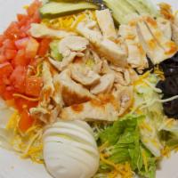 California Chicken Salad · Crisp salad greens topped with a grilled chicken breast surrounded by sliced hard boiled egg...
