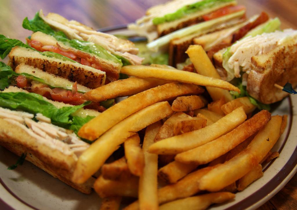 Club House · Toasted triple-decker sandwich loaded with turkey, bacon, lettuce and tomato. Served with fries and choice of soup or side salad