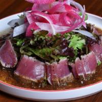 Sashimi Salad · 7 pieces. Seared tuna sashimi on a bed of mixed field greens served with matsuhisa soy onion...
