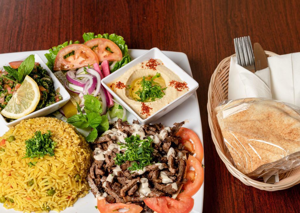 Beef Shawarma Plate · Marinated tri-tip, thinly sliced and flame-broiled, always fresh, hand cut served with your choose of Rice, French Fries  or bulgur with 2 cold appetizers of your choice.