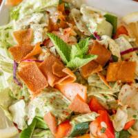 Fattoush Salad · A delightful mix of romaine lettuce, tomatoes, cucumber, fried pita chips, spices with lemon...