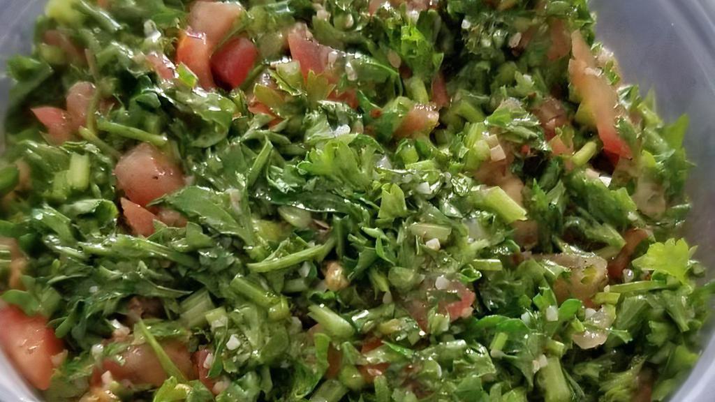Tabbouleh · Finely chopped parsley, bulghur wheat, diced tomatoes and onions, dressed with olive oil and lemon juice.
