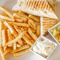 Chicken Shawarma Sandwich · Thin slices of flame-broiled chicken wrapped in pita bread with fries, garlic cream and pick...
