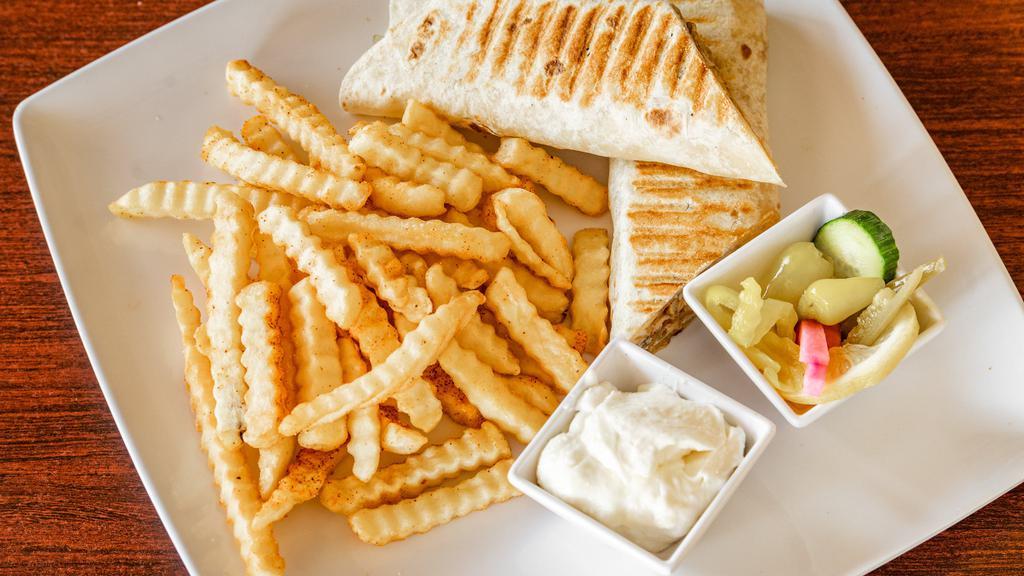 Chicken Shawarma Sandwich · Thin slices of flame-broiled chicken wrapped in pita bread with fries, garlic cream and pickles.
