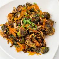 Almond Brussels Sprouts · Fried brussels sprouts mixed with almonds, paprika, and orange confit.