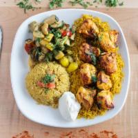 Chicken Kabob Plate · Two skewers of grilled chicken kabob on top of fluffy white rice, topped with onions and par...