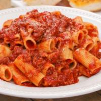 Pasta Bolognese · Al dente fettuccine pasta tossed in a slow-cooked, rich bolognese sauce of ground beef, toma...