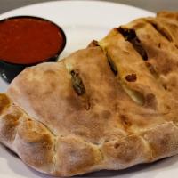 Meat Lovers Calzone · Ricotta and mozzarella cheeses, pepperoni, sausage, ham, and Canadian bacon.