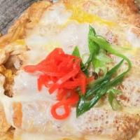Pork Katsu Don · Deep fried pork cutlets, egg, and onions simmered together in a house sauce over rice.