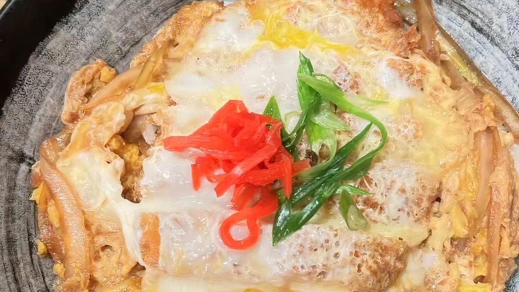 Pork Katsu Don · Deep fried pork cutlets, egg, and onions simmered together in a house sauce over rice.