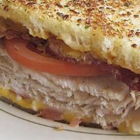 Turkey Melt · Sliced turkey breast with bacon, tomatoes, american cheese and 1000 island dressing. All gri...