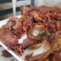Loaded Potatoes · JuJu roasted potatoes baked with shredded mozzarella cheese and crumbled bacon.