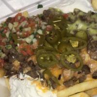 Carne Asada Fries · Carne asada, beans, cheese, avocado sauce, sour cream, pico de gallo and jalapeño.