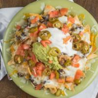 Nachos Grande (Serves 2-4) · Large chips, choice of beans, jack and Cheddar cheese, tomatoes, jalapenos, guacamole and so...
