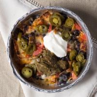 Nachos · Chips, choice of beans, jack and cheddar cheese, tomatoes, jalapenos, guacamole and sour cre...