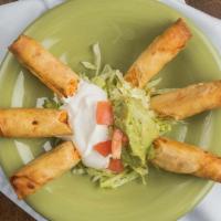 Flautas · Crisp flour tortillas (3) with shredded chicken, topped with guacamole and sour cream.