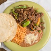 Fajitas · Marinated chicken or steak – with grilled peppers and onions, served with black or pinto bea...