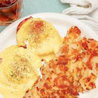 Eggs Benedict · Two Poached Eggs & Ham on a grilled english muffin topped with hollandaise sauce, served wit...