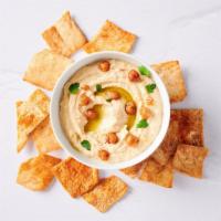 Hummus & Smoked Paprika Pita Chips · Creamy hummus with a side of pita chips sprinkled with paprika