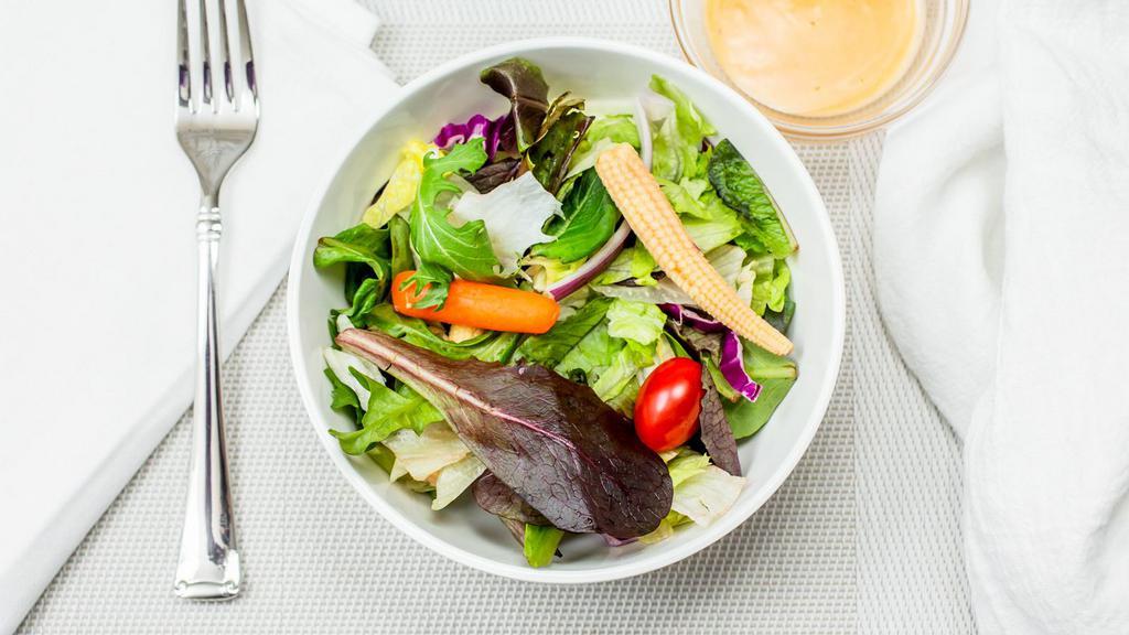 Garden Salad · Fresh lettuce,spring mix, fresh cucumber, red onions, tomatoes, shredded cabbage, baby corn and shredded carrots with your choice of dressing.