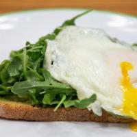 Avo Egg Toast · Fried egg on top of arugula, avocado and marbled rye toast