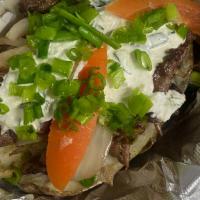 Gyro Potato · Buttery baked potato with seasoned beef gyro, grilled onions tzatziki spread, tomatoes toppe...