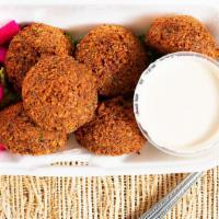 Falafel · Fresh chickpeas and fava beans mixed with parsley and Lebanese spices, served with lettuce, ...