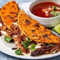 Birria Taco · Slow cooked Angus beef seasoned with traditional Mexican spices, topped with onion and cilan...