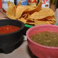 Chips And Salsa · Fresh corn chips served with our homemade Red and Green Salsa. Vegetarian-friendly.