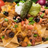 Ultimate Nachos · Tortilla chips topped with house-made chili or chile verde, melted cheese, pico-de-gallo, gr...