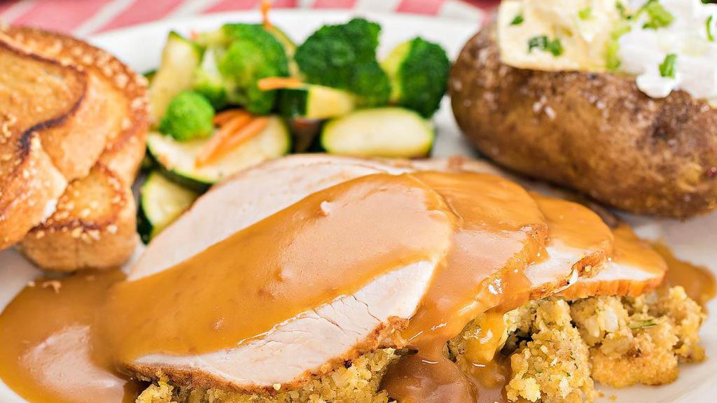 Roasted Turkey · Slow roasted and hand carved, piled high over cornbread stuffing and topped with gravy.