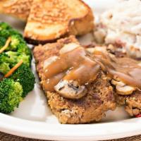Home-Style Meatloaf · Slow roasted and sliced thick, topped with mushroom and gravy.