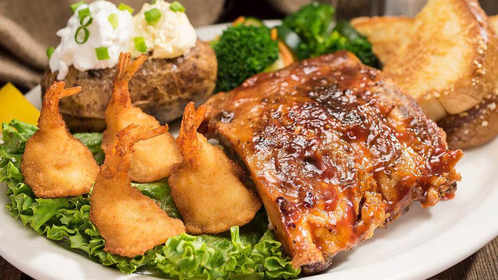 Baby Back Ribs & Shrimp · Baby back ribs rubbed with brown sugar and slow roasted until tender, paired with four fantail shrimp.