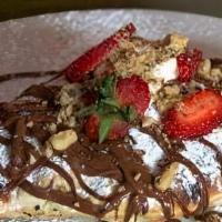 Nutella Calzone · Calzone stuffed with Nutella, bananas, and berries, fried and sprinkled with powdered sugar.