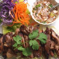 Grilled Pork · Slices of grilled pork marinated with Thai herbs and spices. Served with Thai chili lime sau...